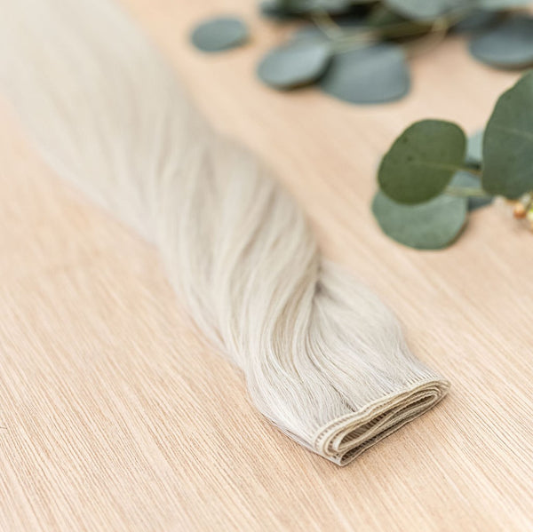 ASPEN HIBER WEFT Aspen Hiber Weft is a 22" weft is a natural level 10 ash platinum blonde shade. These wefts offer customization options, including custom sizing, cut, and a seamless fine root base without a return edge. The Hiber Wefts are 22" in length