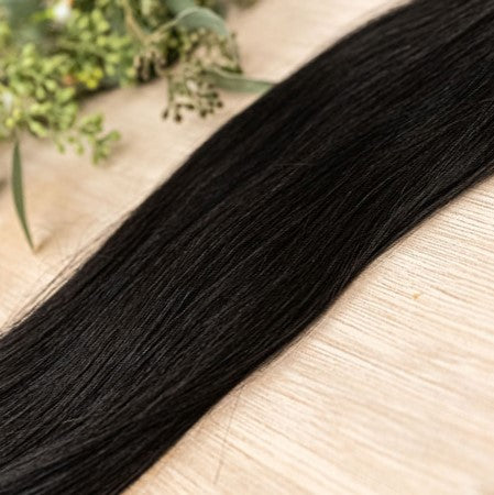 EBONY MACHINE WEFT 50g Ebony machine weft is a 22" weft featuring natural-toned level 1 brown with warm undetone. These machine wefts offer the highest weft density, along with the flexibility to be custom sized, colored, and cut according to your prefere