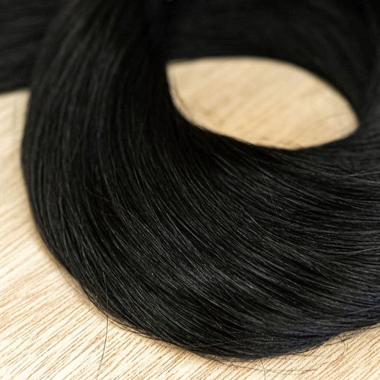 RAVEN CLIP IN Raven clip-in hair extensions are 22 inches in length and made of a gorgeous weft of natural-toned level 1 blue based black. They provide instant density and length when applied to the hair. These clip-in extensions can be customized in term