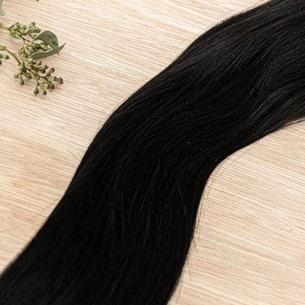 RAVEN MACHINE WEFT 50g Raven machine weft is a 22" weft featuring natural-toned level 1 blue black base. These machine wefts offer the highest weft density, along with the flexibility to be custom sized, colored, and cut according to your preferences. The